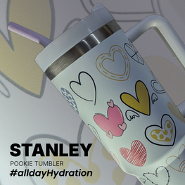 Stanley tumbler with heart designs on a light background
